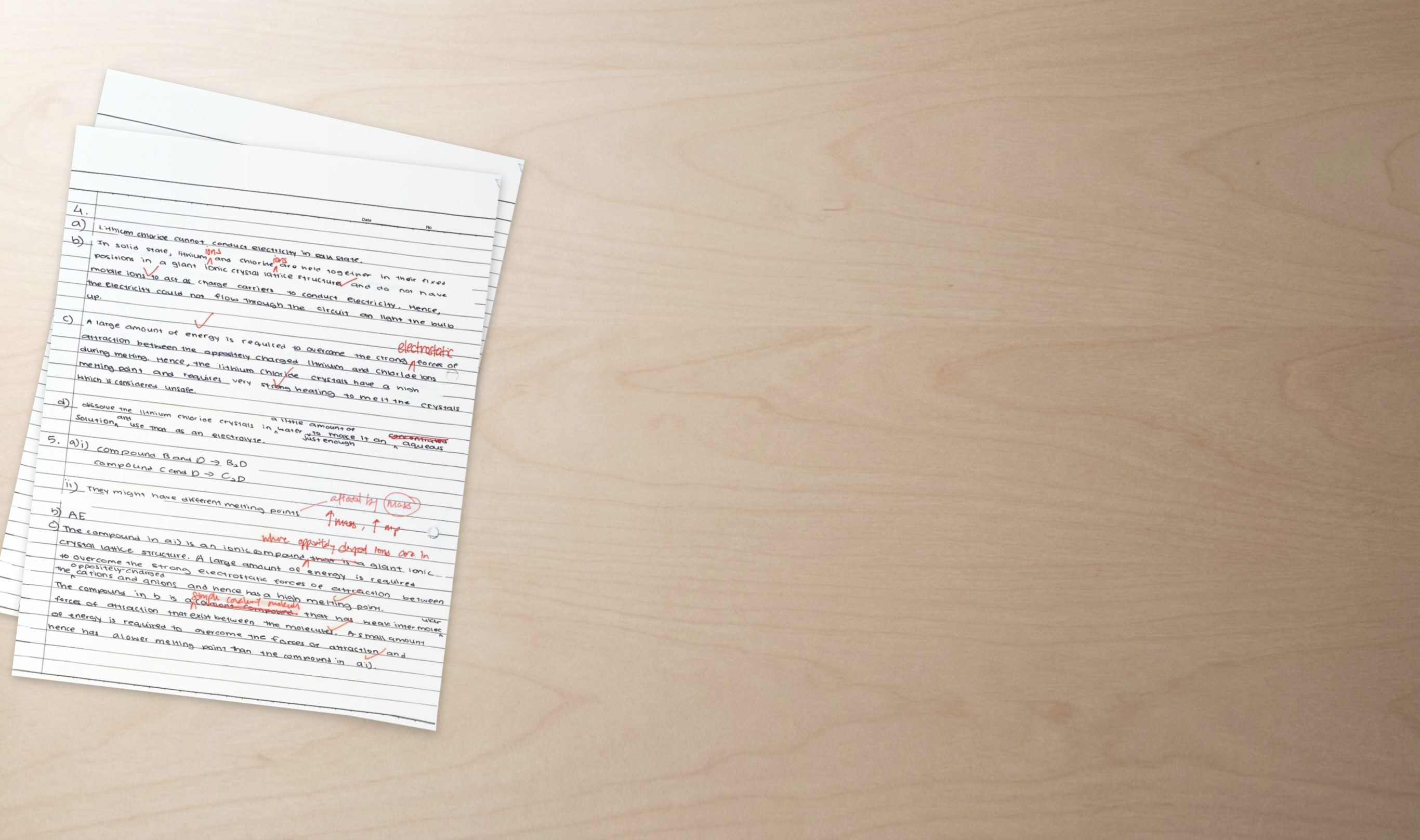 A Secondary 4 Chemistry answer script marked in red pen, with corrections to the wording of an explanation about melting points